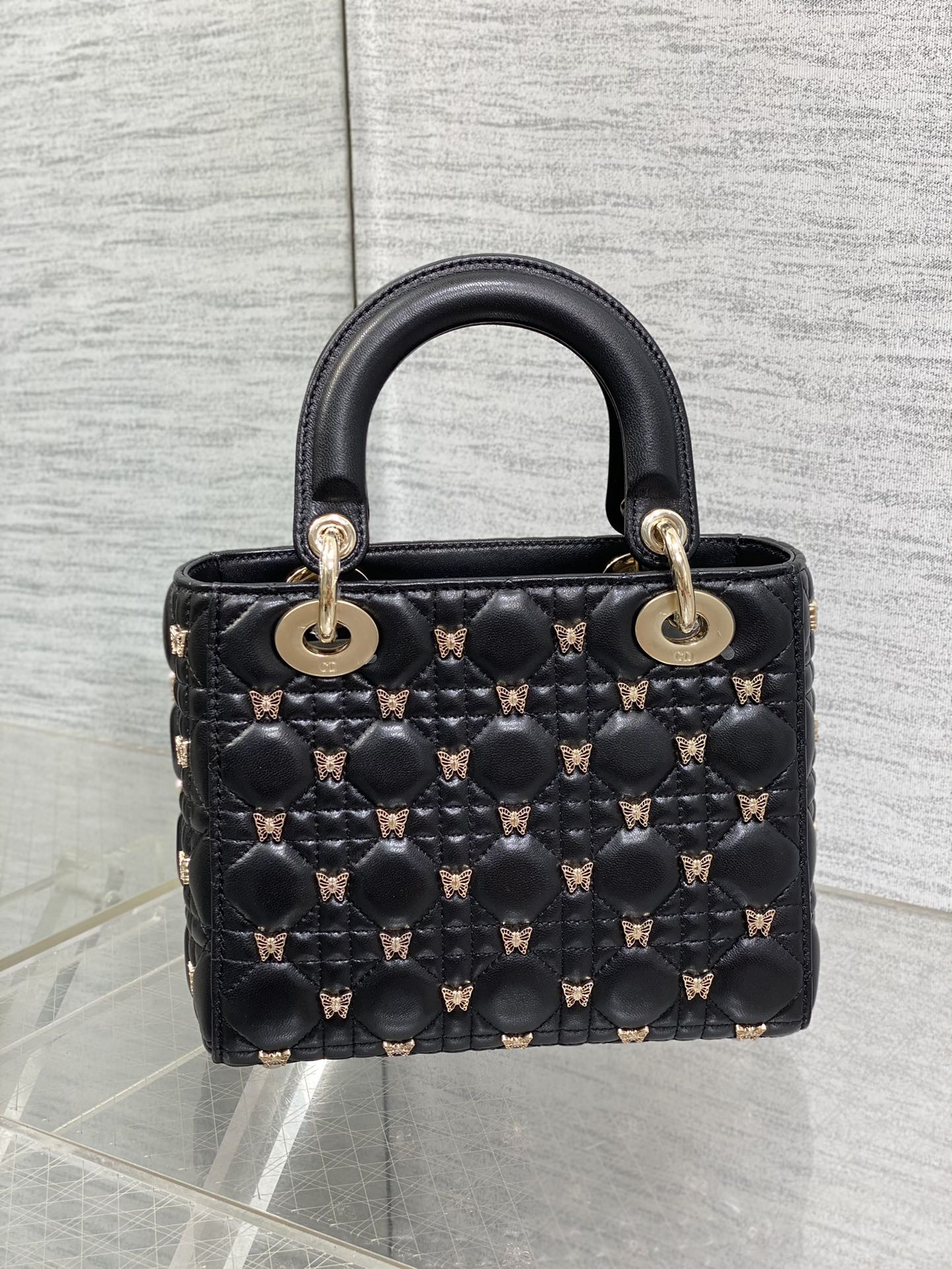 small lady D*or black with butterfly studs