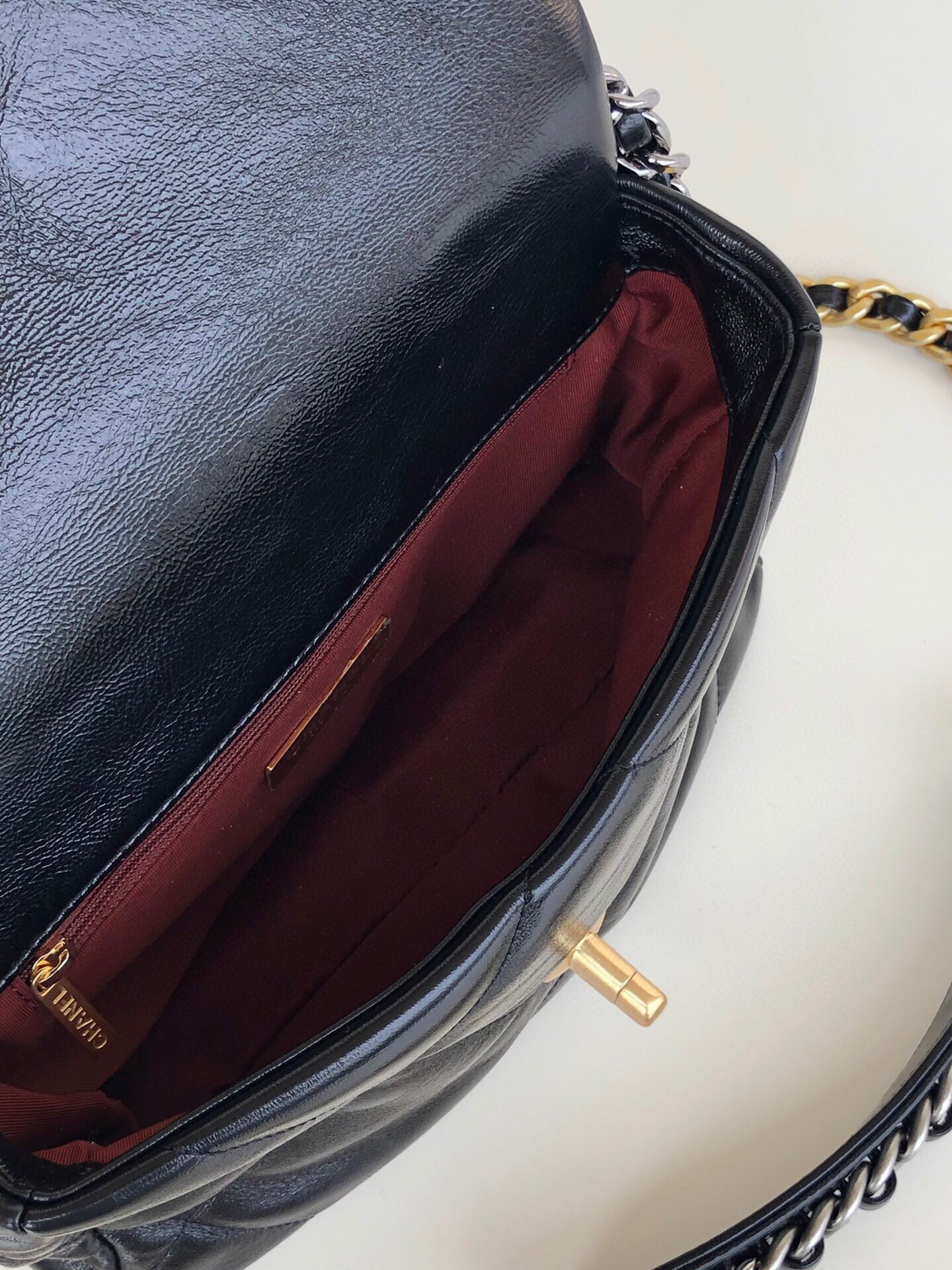 Ch*el 19 handbag shiny leather, gold-tone, silver-tone & ruthenium-finish metal black 6.2 × 10.1 × 3.5 in
