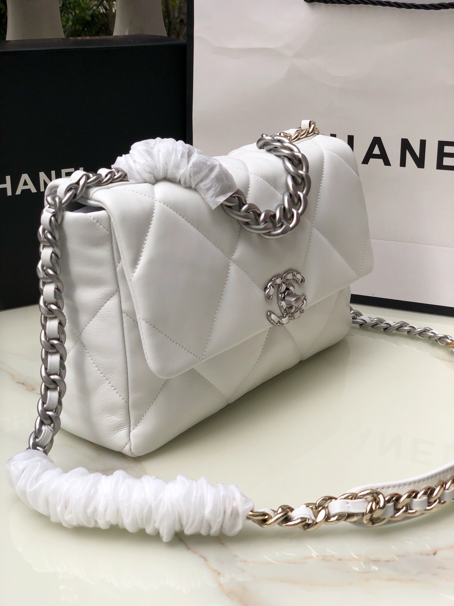 Ch*el 19 large handbag shiny leather, gold-tone, silver-tone & ruthenium-finish metal white 7.8 × 11.7 × 3.9 in