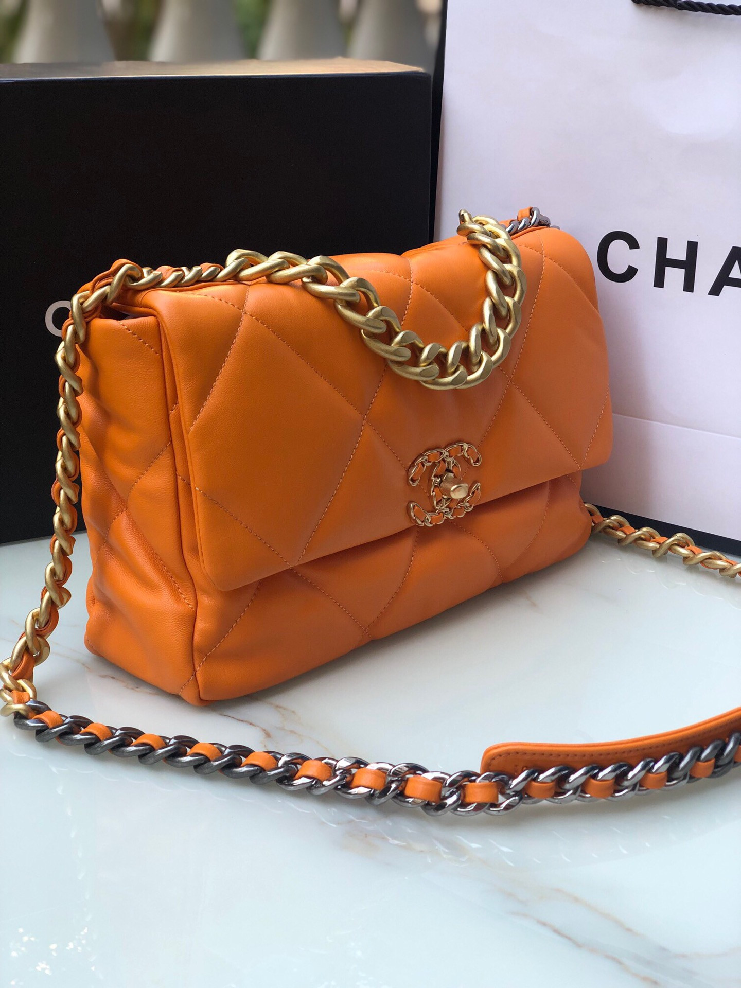Ch*el 19 large handbag shiny leather, gold-tone, silver-tone & ruthenium-finish metal orange 7.8 × 11.7 × 3.9 in