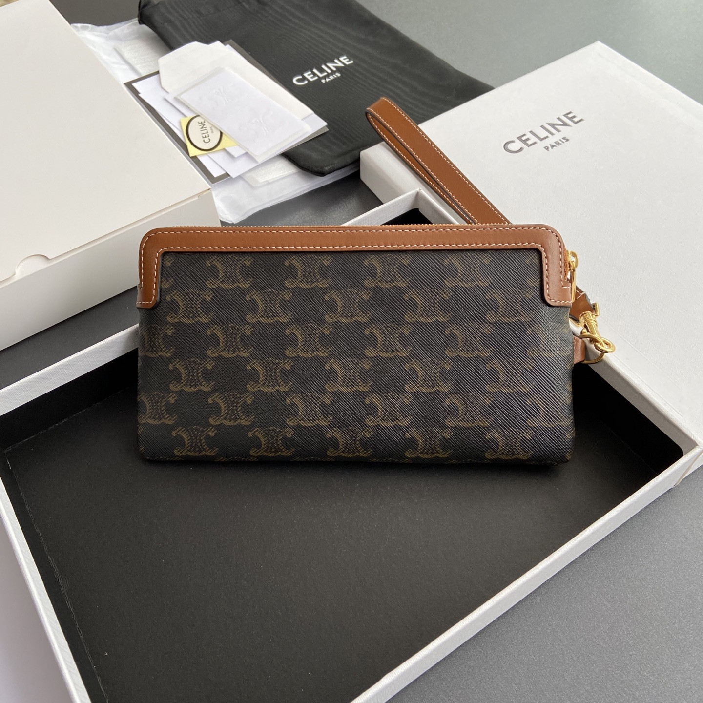 Ce**e long pouch with strap in triomphe canvas and calfskin 21.5x11.5x1cm
